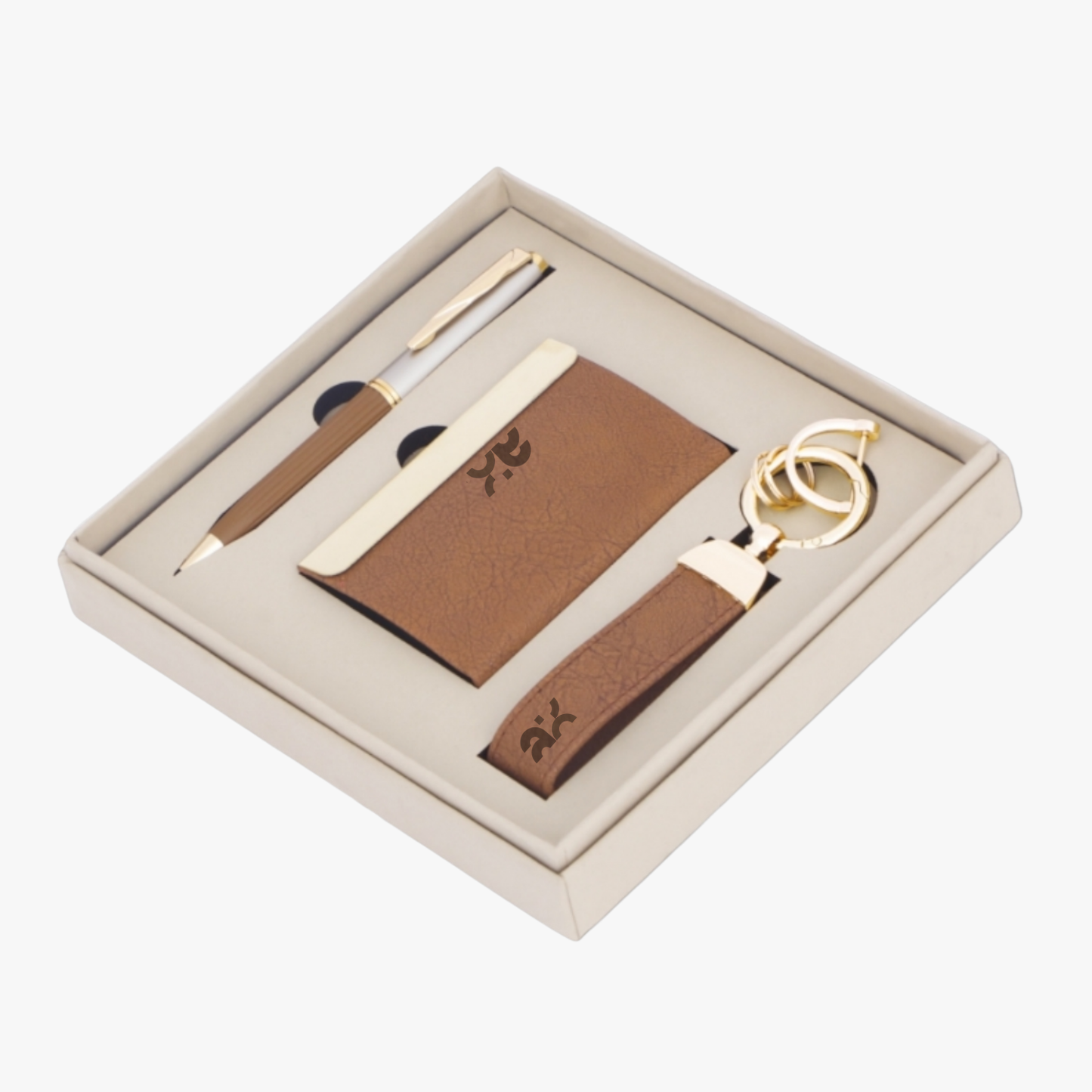 Set of brown leather items including a pen, cardholder, and keychain in a box on a white background