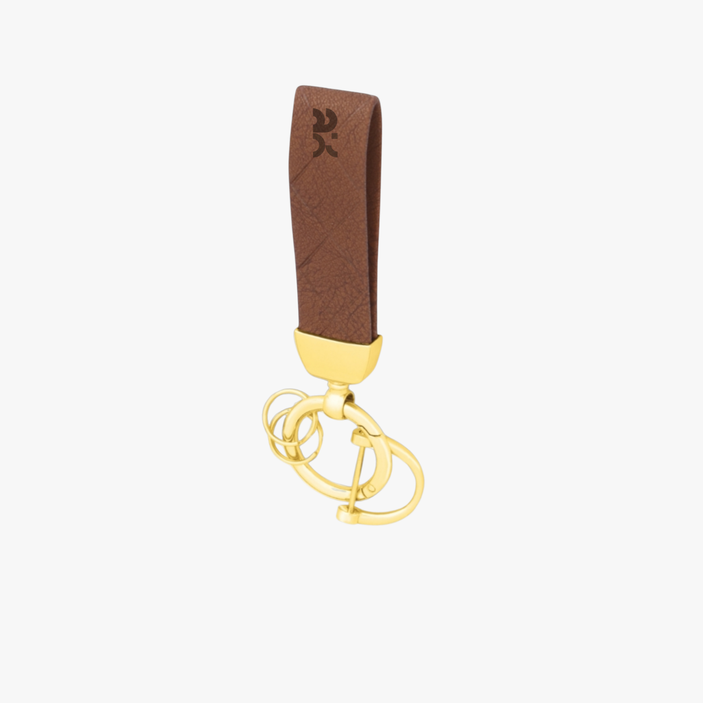 Gold keychain with a brown leather strap on a white background