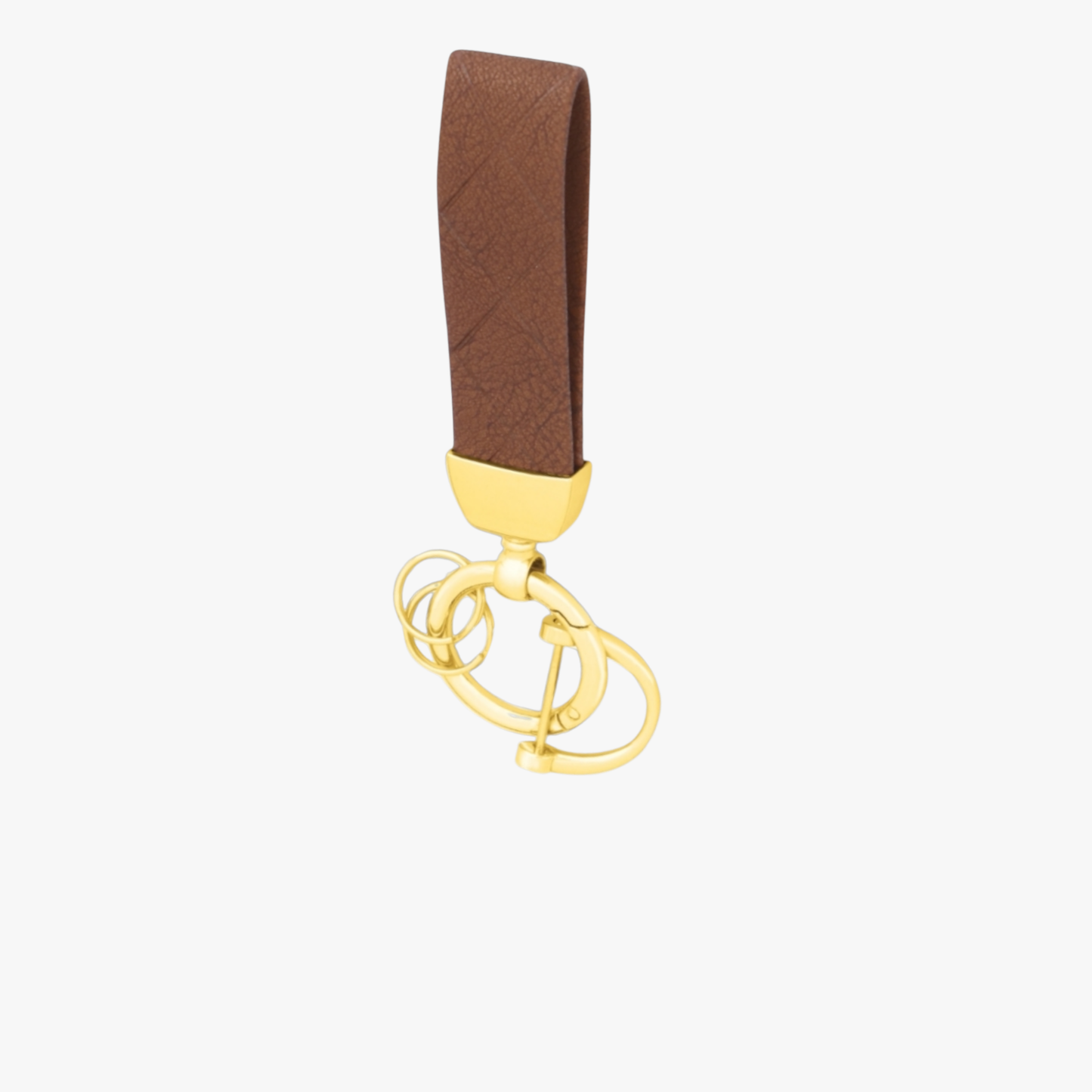 Gold keychain with a brown strap on a white background