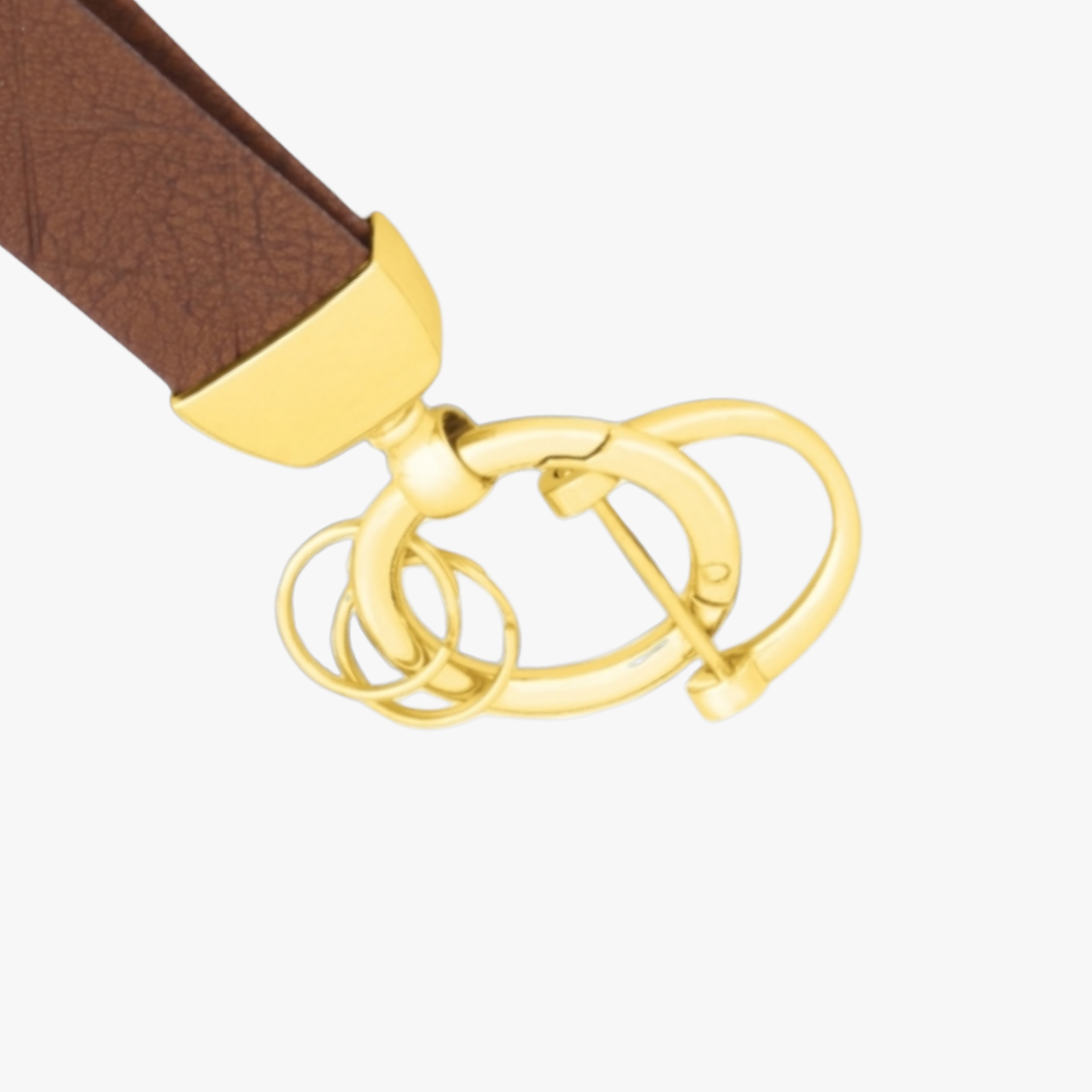 Gold belt buckle with a brown leather strap on a white background