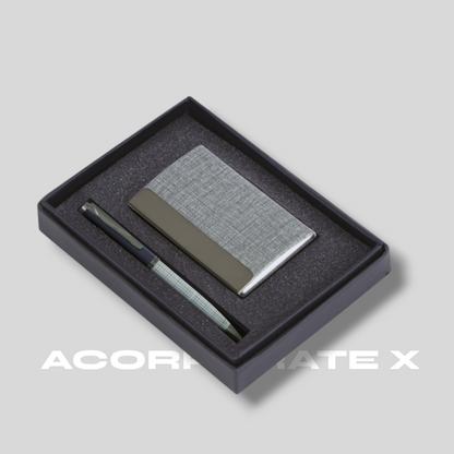 A business card holder and a pen presented in a black box with a silver accents. The brand 'ACORRANTE X' is visible on the bottom.