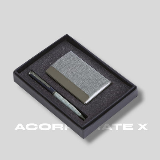 A business card holder and a pen presented in a black box with a silver accents. The brand 'ACORRANTE X' is visible on the bottom.
