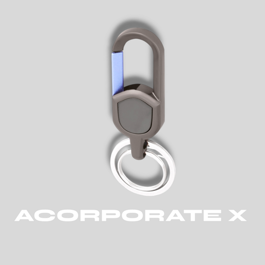 Metallic keychain with a carabiner on a light gray background, featuring the brand 'ACorporate X'.