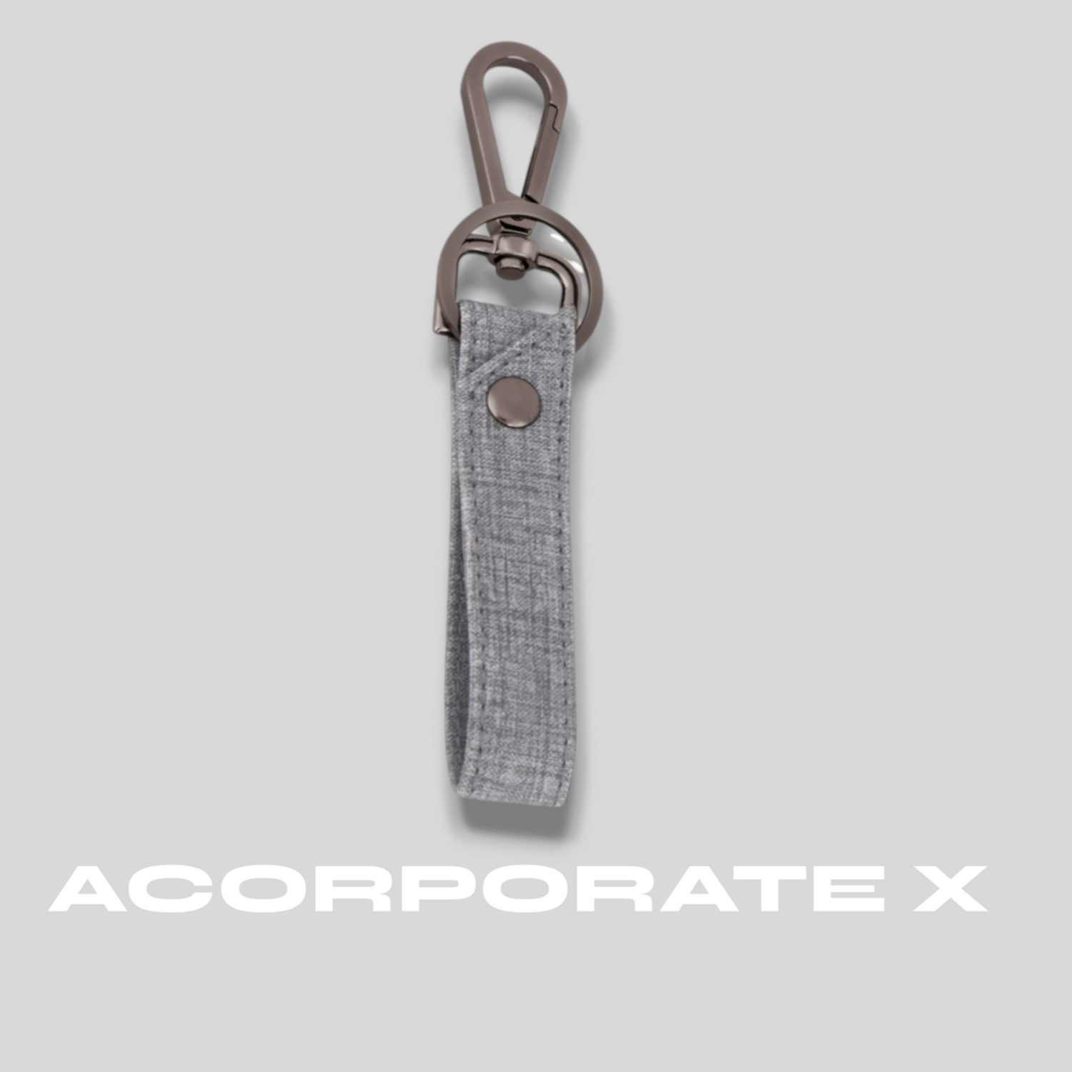Gray keychain with a clip on a light gray background, featuring the brand 'ACorporate X'.