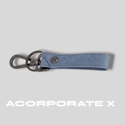 Blue keychain with metal clip on a gray background, featuring the brand 'ACorporate X'.