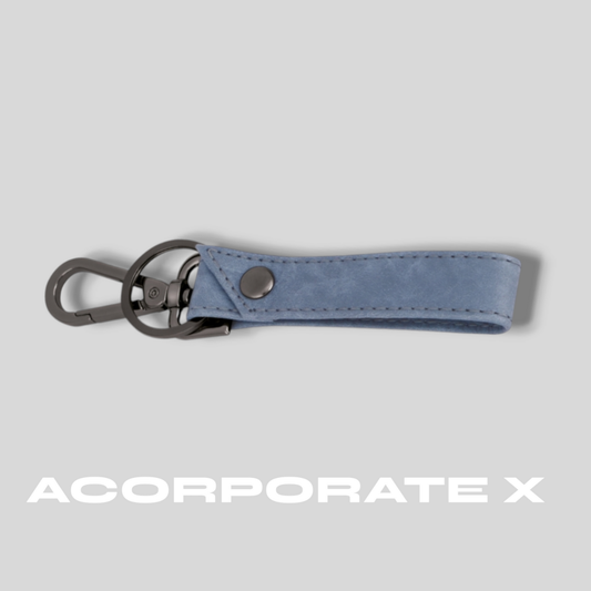 Blue keychain with metal clip on a gray background, featuring the brand 'ACorporate X'.
