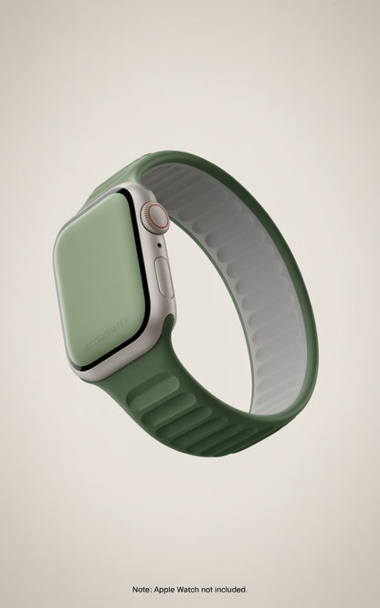 A green silicone band for a smartwatch, with a silver metal clasp and a green digital screen.