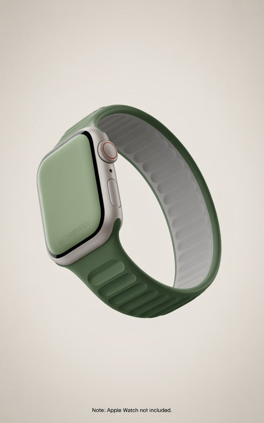 A green silicone band for a smartwatch, with a silver metal clasp and a green digital screen.
